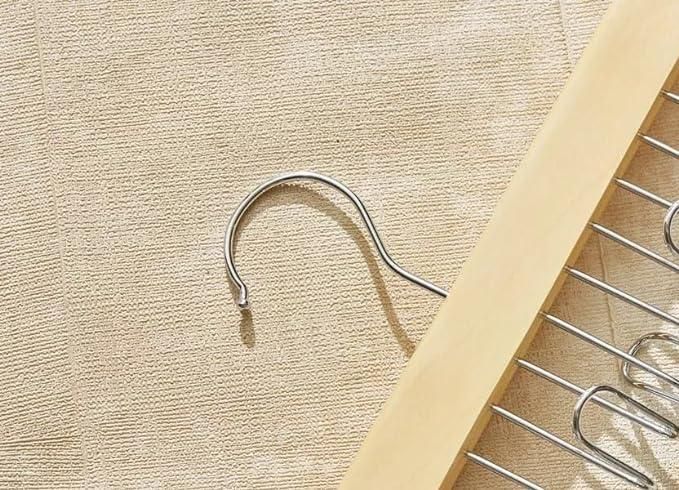 Close view of a single wooden accessory organiser showing its smooth wooden bar and full row of metal loops